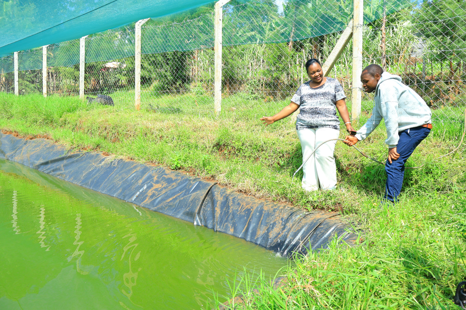 Fisheries Officer Victoria Mulama with Ng'ainet Visionary Youth Group, a youth fish farming group in Ndarawetta ward, during pond site visit on extension services. Photo/ Kipyegon Chirchir